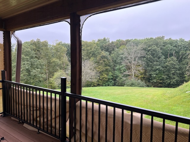 Custom porch enclosure panels on a covered deck